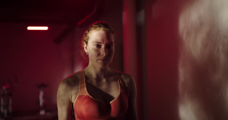 A woman is doing cardio in a gym during day time