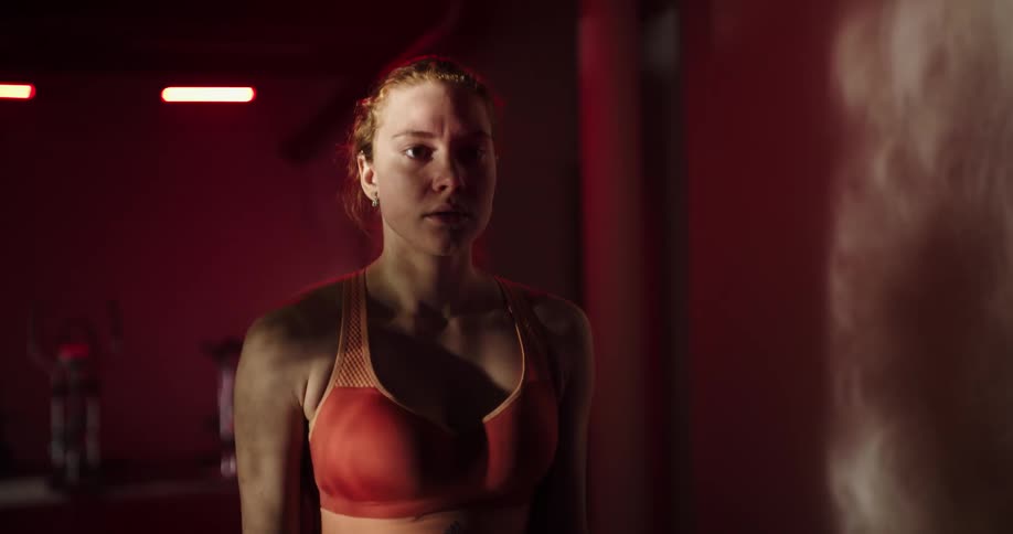 A woman is walking in the gym