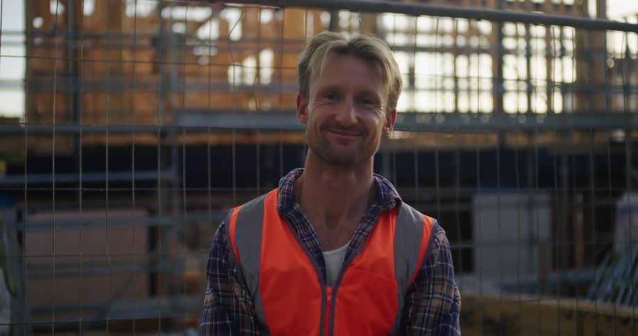 A man is posing in front of the construction site