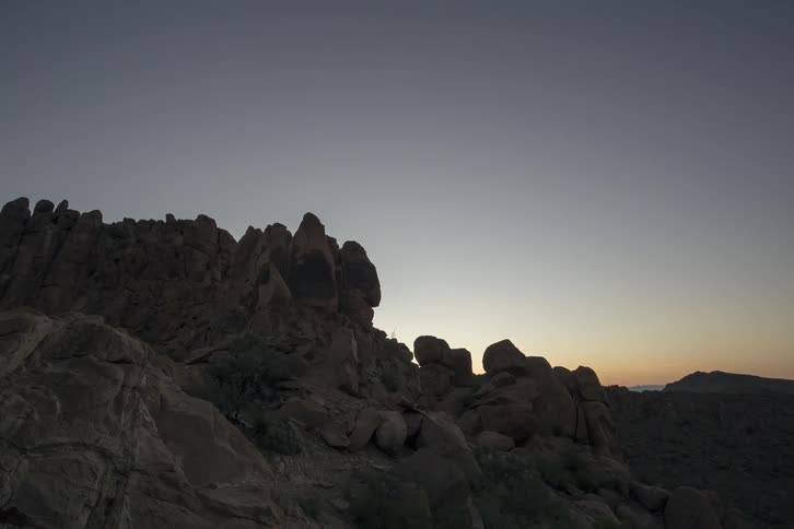 The sun rises over mountains