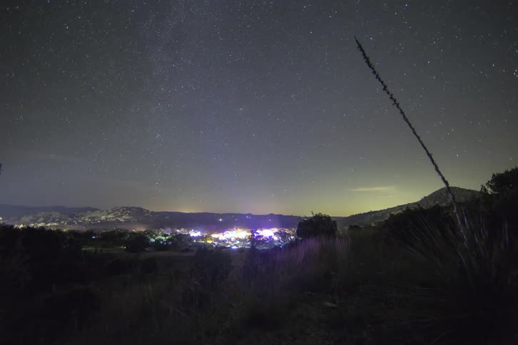 A city lights up in a valley