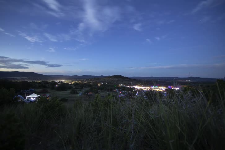 Time lapse of clouds passing over the bustle of city lights