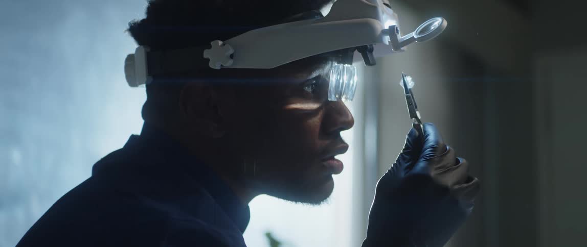 A jeweler closely examines a gemstone