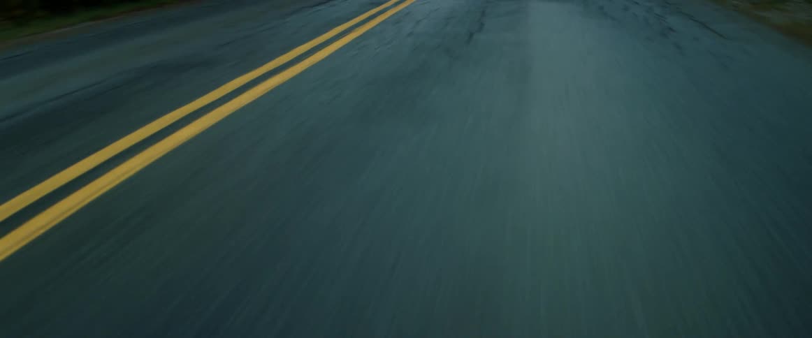 Close up of a roadway with yellow lines running down the middle
