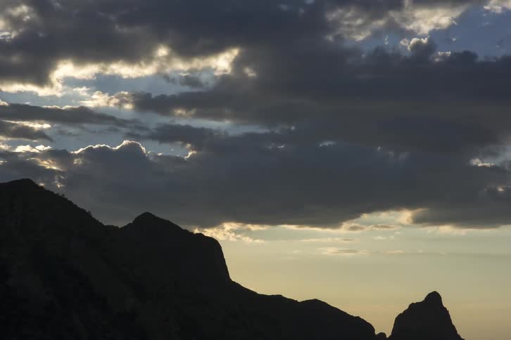 Clouds roll through the sky at sunrise