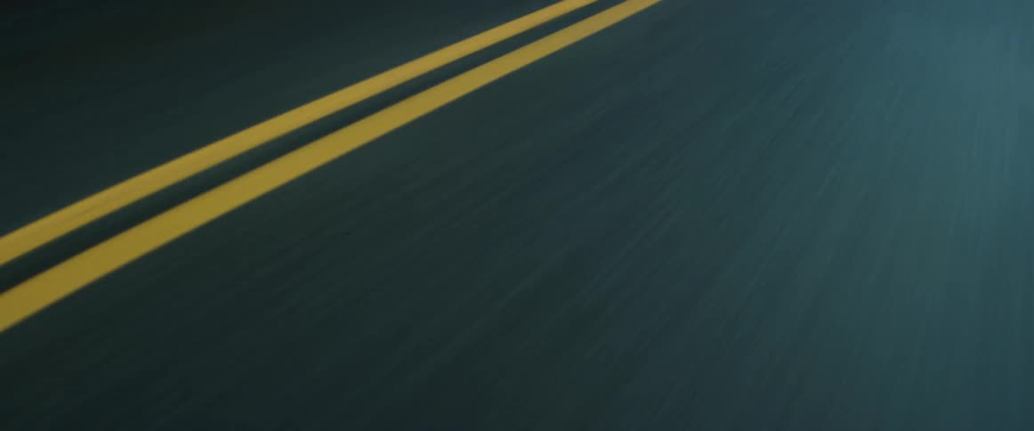 Vehicle drives on highway with yellow lanes