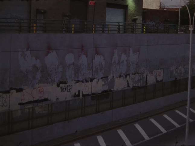 People walk and ride bikes past the freeway
