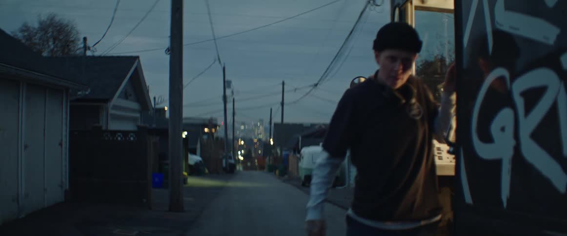 A person getting out of their truck on the street in the suburbs