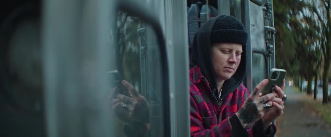 A woman is outside using her cell phone