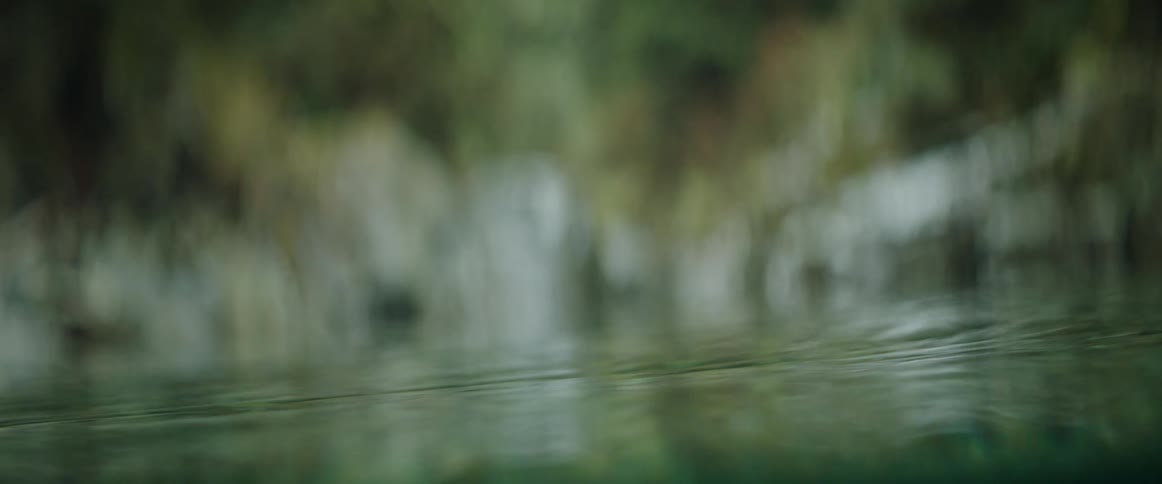 Semi-submerged abstract textures of water in a rocky natural pool