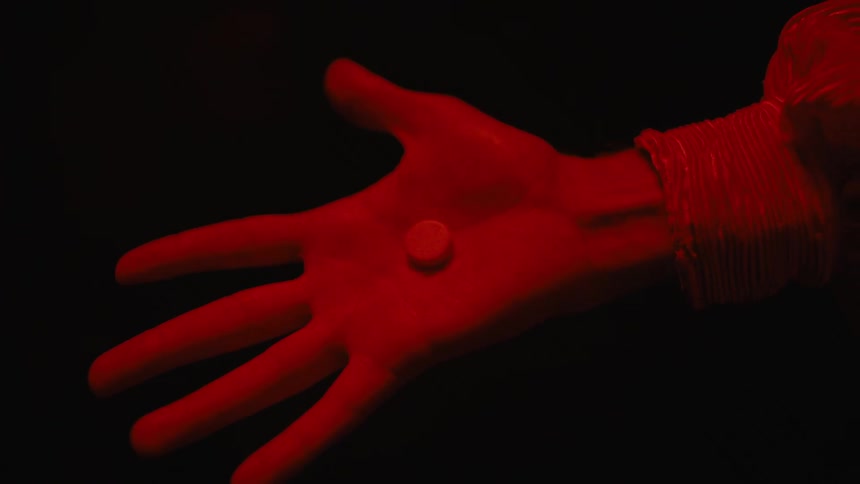 Woman opens her hand with pill