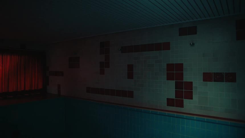 Panning shot of a pool from the tiles to a curtain