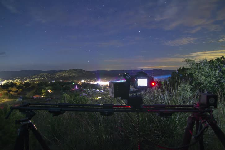 A camera moves on a track filming a town ahead