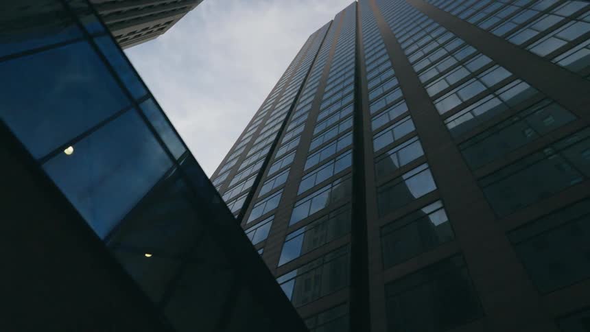 The outside of a high rise office building in a city
