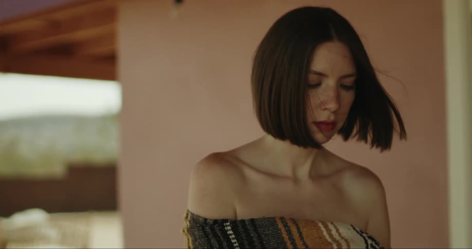 Woman in a blanket walking her house