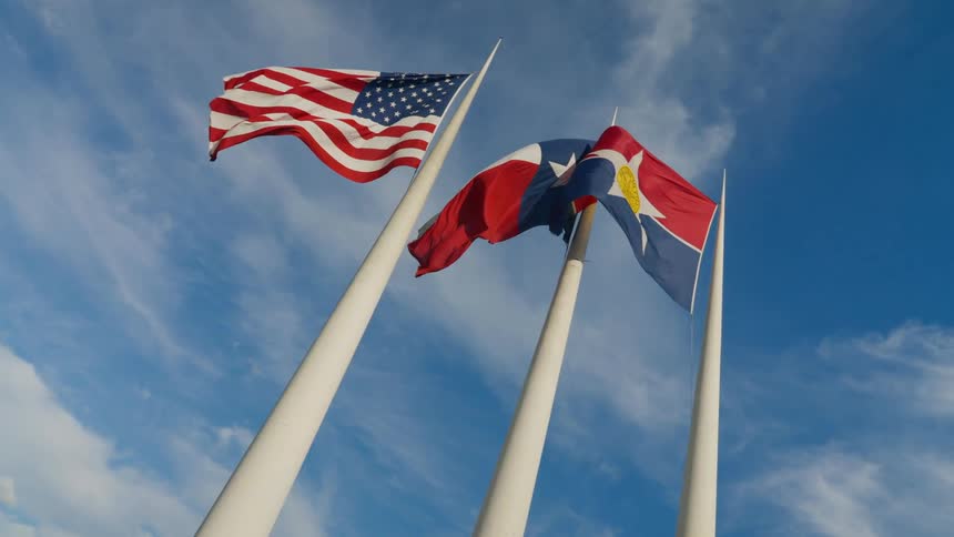 Tall flags billowing in the wind in the daytime