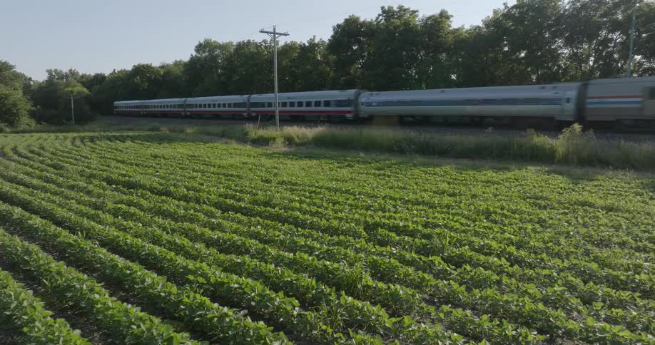 A passenger train speeds by rural countryside