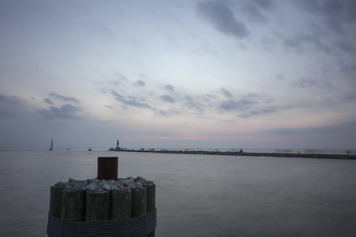 Boats pass through the water along the shoreline