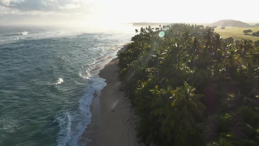 Travelling over a tropical beach as waves roll onshore