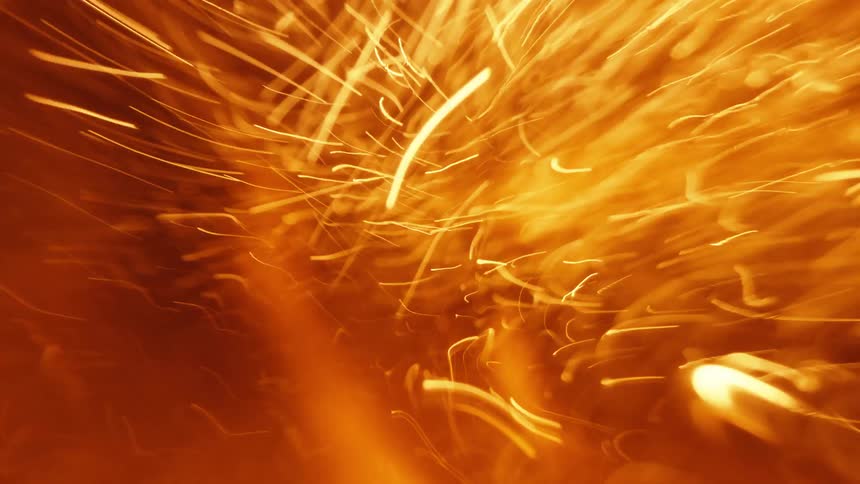 Explosive orange sparks fly and spread outward