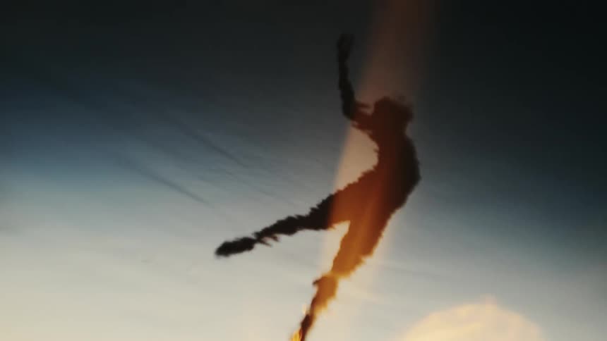 A silhouette of a persons reflection dancing