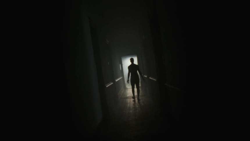 Man walking corridor is silhouetted