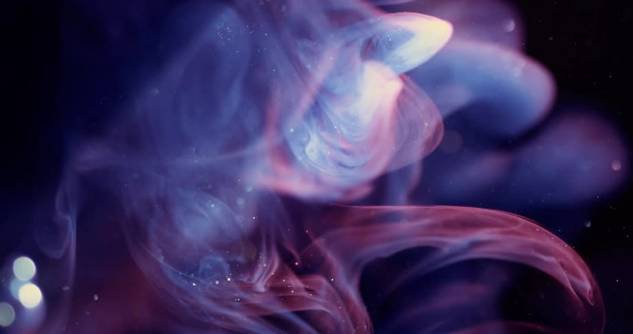 Cloud of white blue and magenta smoke shimmering against a black background