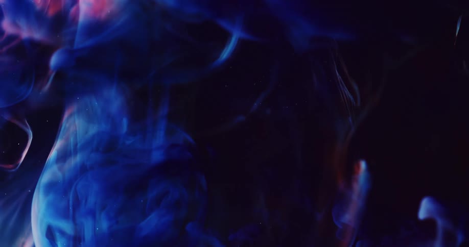 Red and blue wisps move across the darkness as billows of a thick electric blue substance moves over them