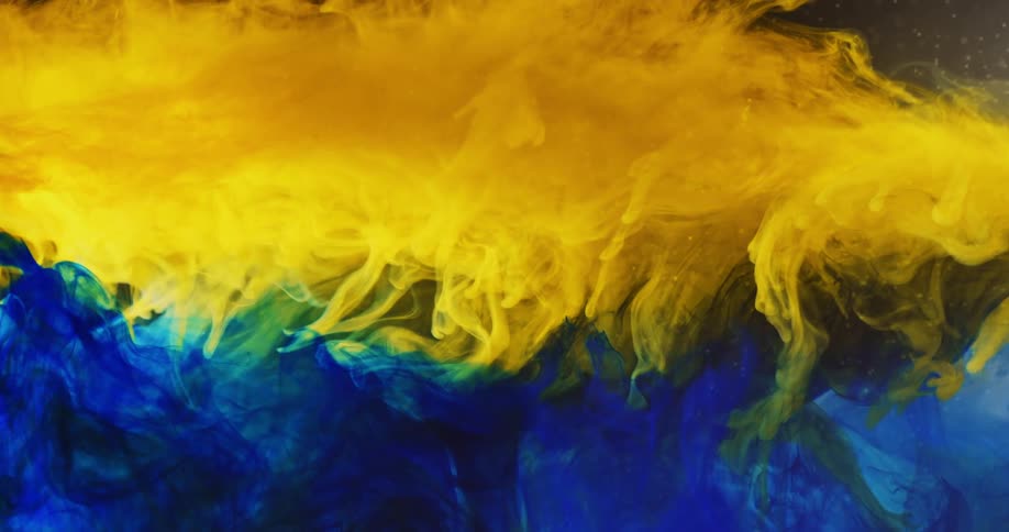 Yellow paint swirls and combines with blue paint