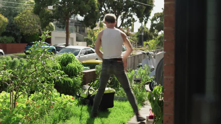 A man is mowing the lawn