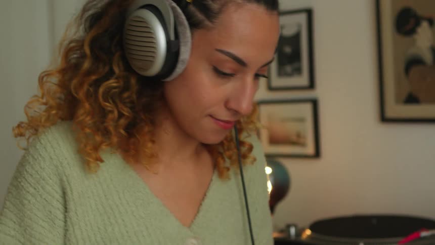 A woman is listening to music on her headphones