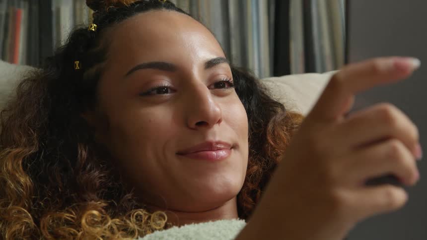 A woman smiling holding something in her hands