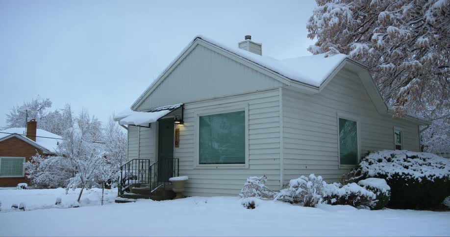 A view of a house covered in snow