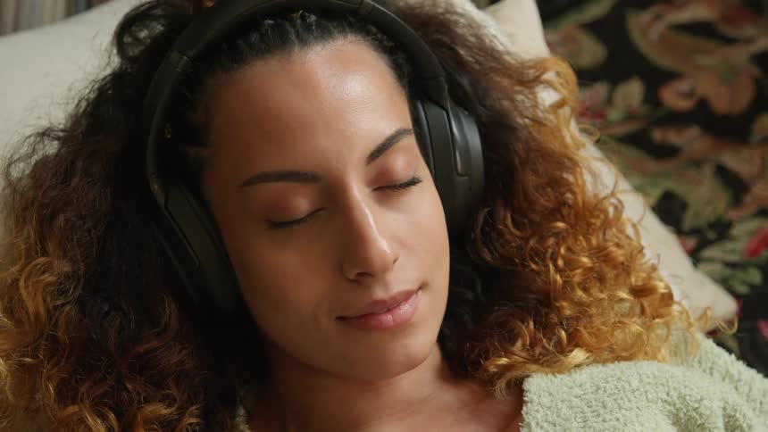 A woman listening to music on headphones