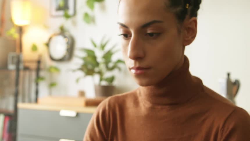 A woman types on her laptop in the office