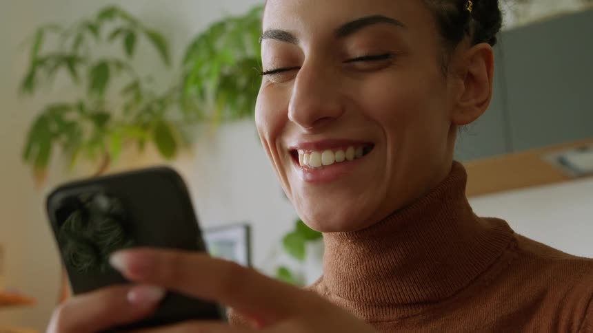 A woman looking at her phone smiling