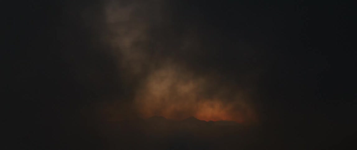 Gold smoke circles over a light source