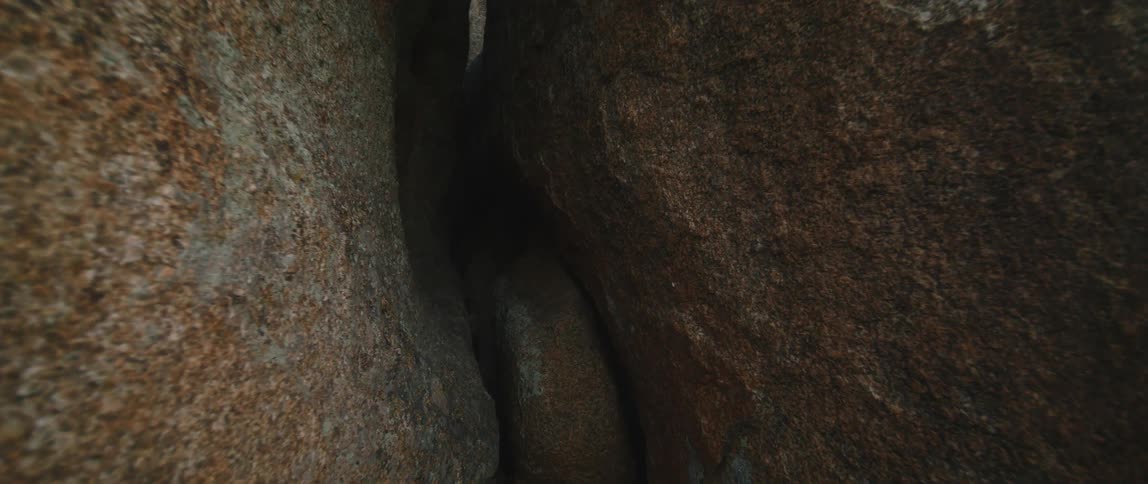 An opening to a cave between large boulders