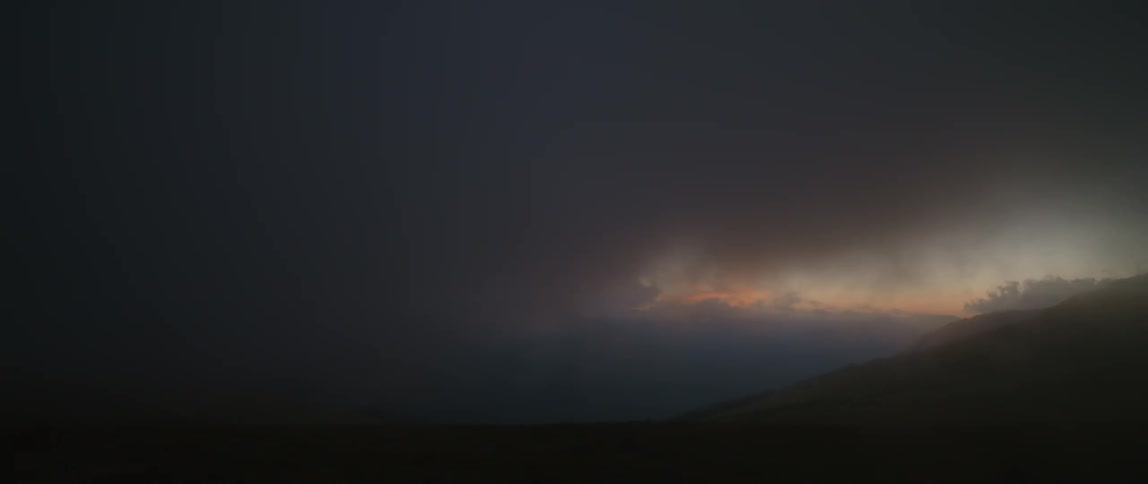 Dark clouds roll across hills and fields to obscure red horizon