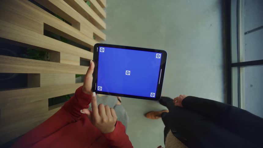 Businessman and businesswoman work on tablet in the office