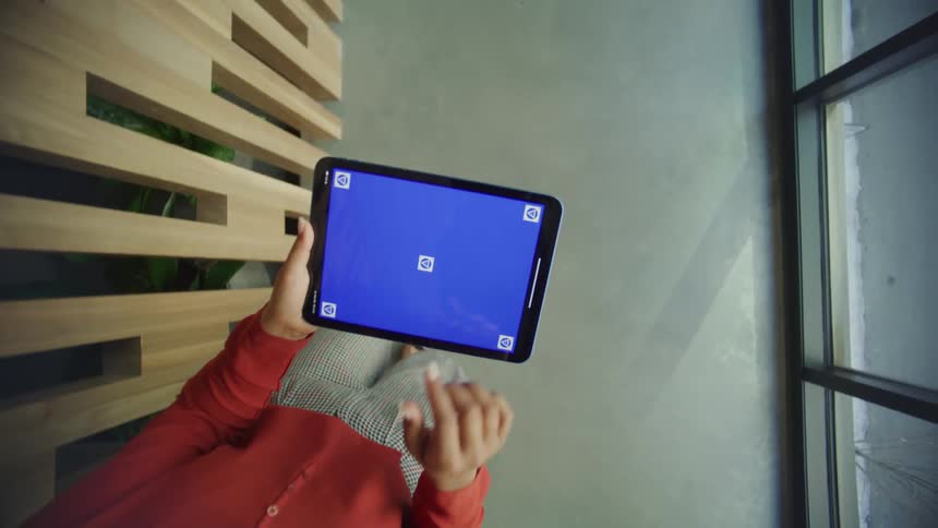 A woman walking using a tablet with her fingers