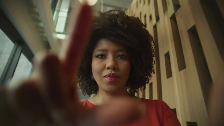 A black woman acting as shes touching a screen