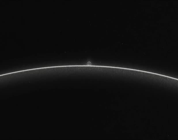Black and white distorted footage of a moon or planet rising over the horizon