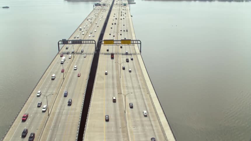 Aerial footage of light traffic on the Woodrow Wilson Memorial Bridge over the Potomac River in Maryland