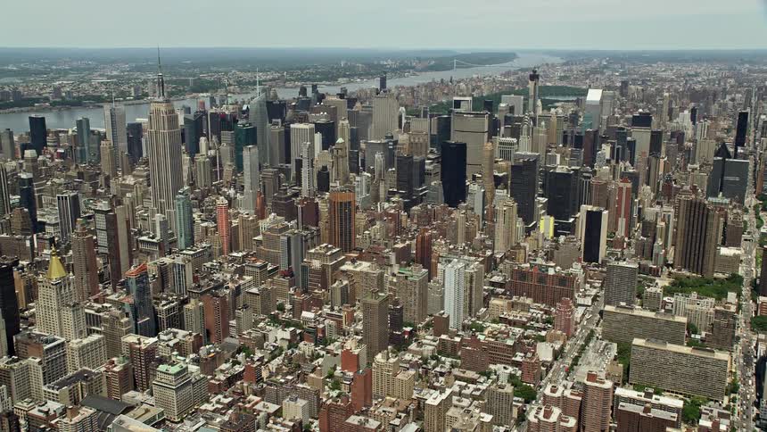 A stunning aerial view of Midtown Manhattans towering high-rises amidst a sunny day in New York City