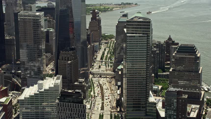 Aerial footage of One World Trade Center and surrounding streets in Lower Manhattan on a sunny day