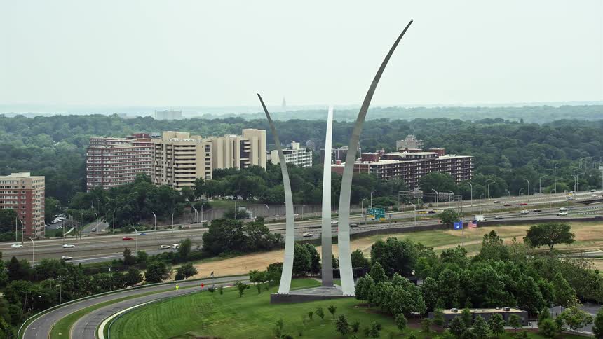 Aerial footage flying by the United States Air Force Memorial at Arlington National Cemetery in hazy weather located in Washington DC