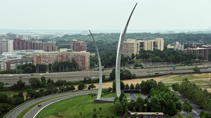 Aerial footage of the United States Air Force Memorial at Arlington National Cemetery in Washington DC on a hazy day