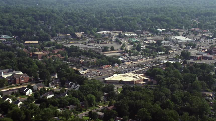 An aerial view of the retail and shopping centers along Columbia Pike in Annandale Virginia during a hazy summer day