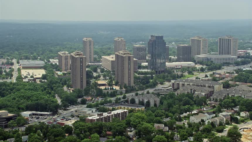 Aerial footage of apartment complexes and the Social Security Administration office building in Falls Church Virginia on a hazy day